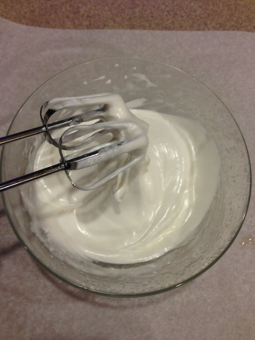 Then in your other bowl, Beat your egg whites and carefully add sugar by tablespoon. Once sugar is incorporated add your cream of tartar and salt.