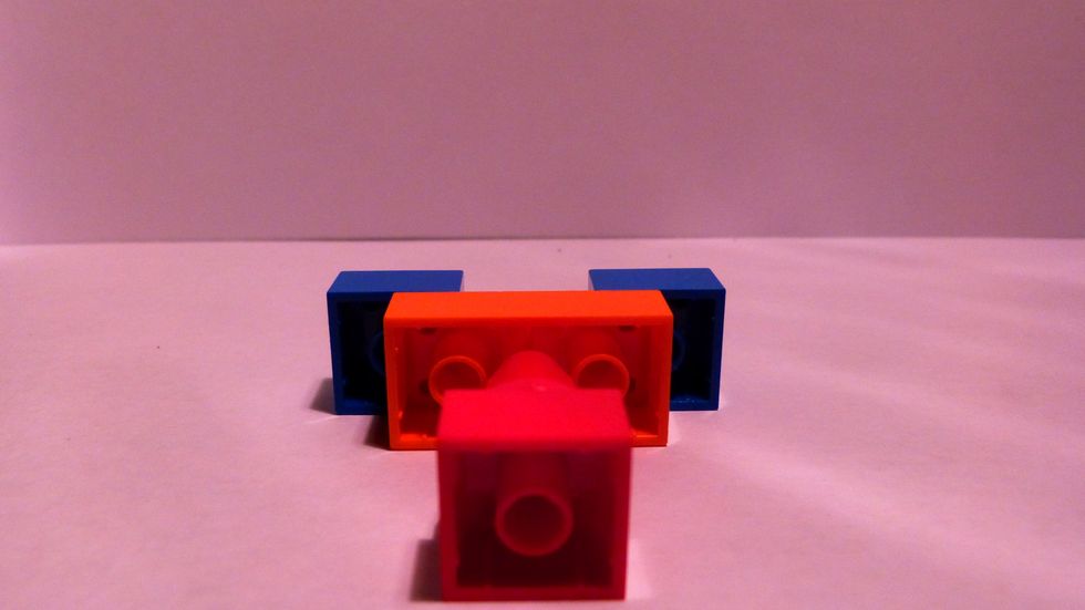 Then insert the cone's top into the center peg of the 2x4.