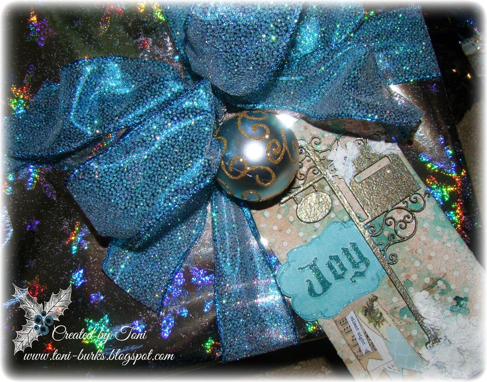 Then just add your embossed chipboard pieces and scraps of coordinating Christmas paper in layers for interest.