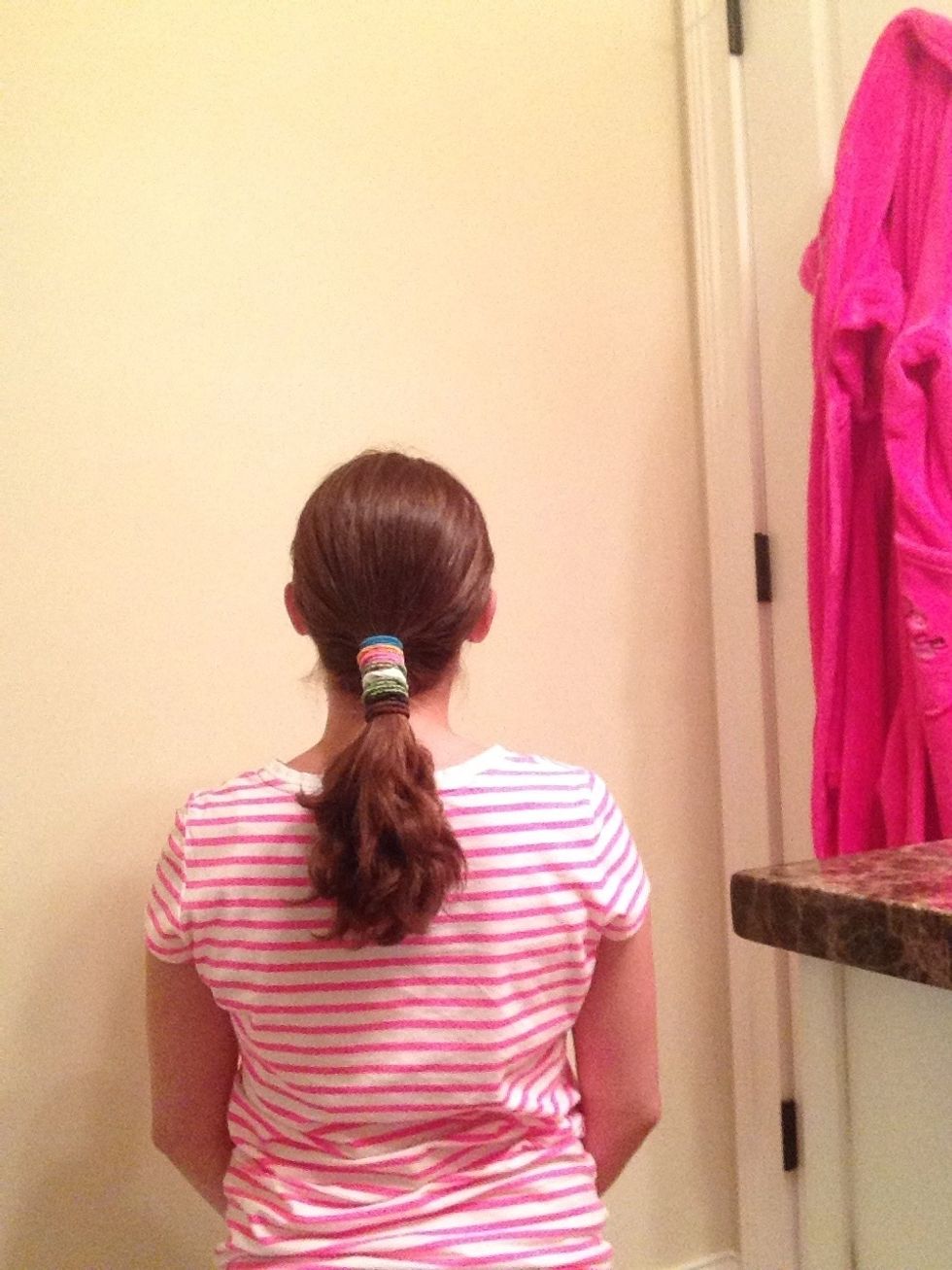 Then, just starting putting ponytail holders on your ponytail! Stop about every three holders to tighten your ponytail so it doesn't get loose. Be careful not to overlap ponytail holders.