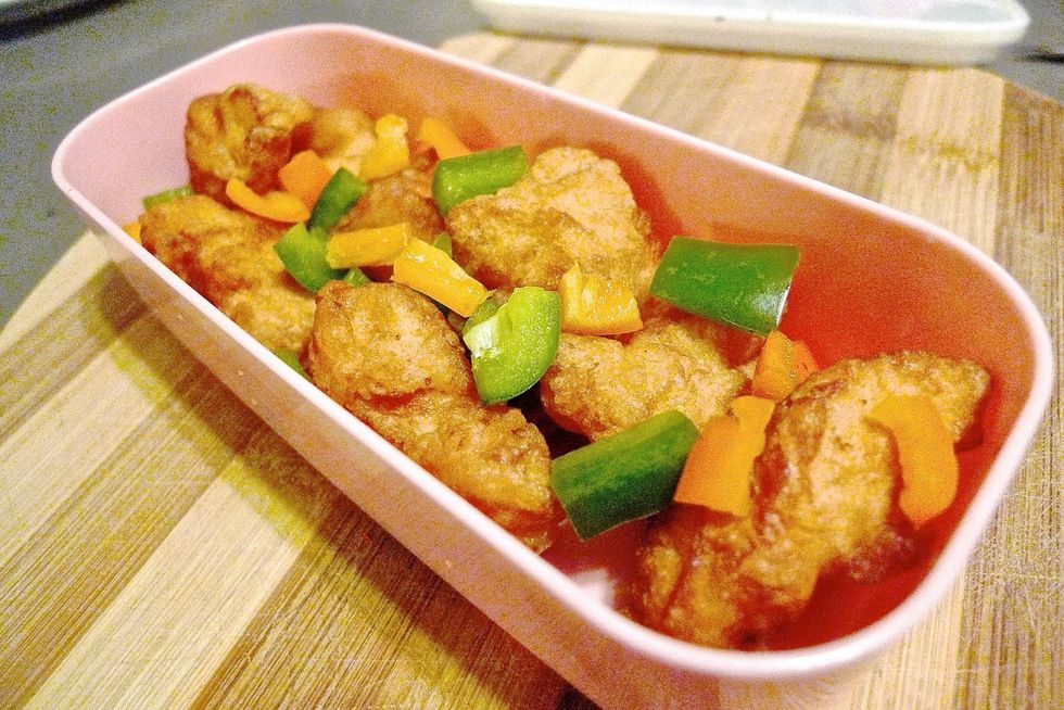 Then layer the colorful bell peppers over the cooked chicken.