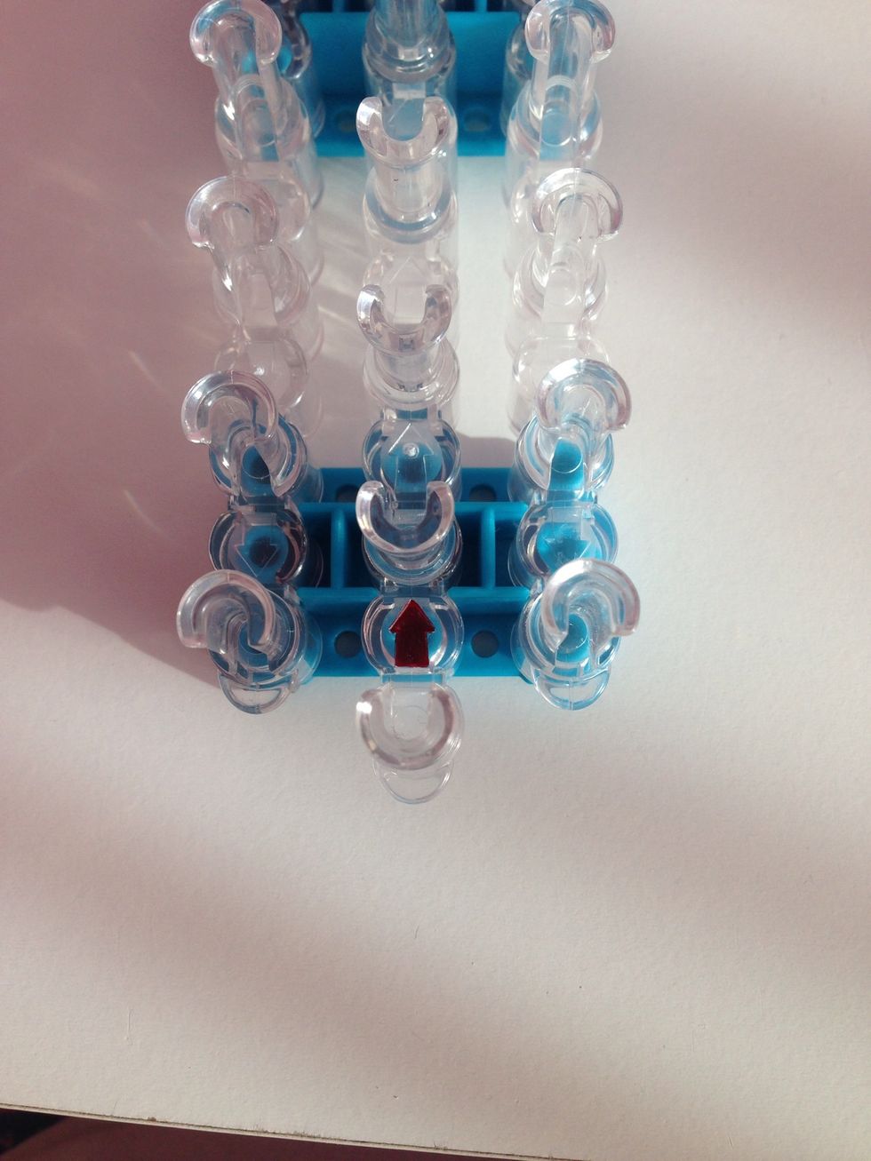 Then line up the arrow with the pegs.