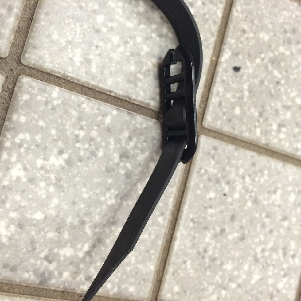 Then, loop one end of the goggle strap in, then out, then back into the tightening connector.