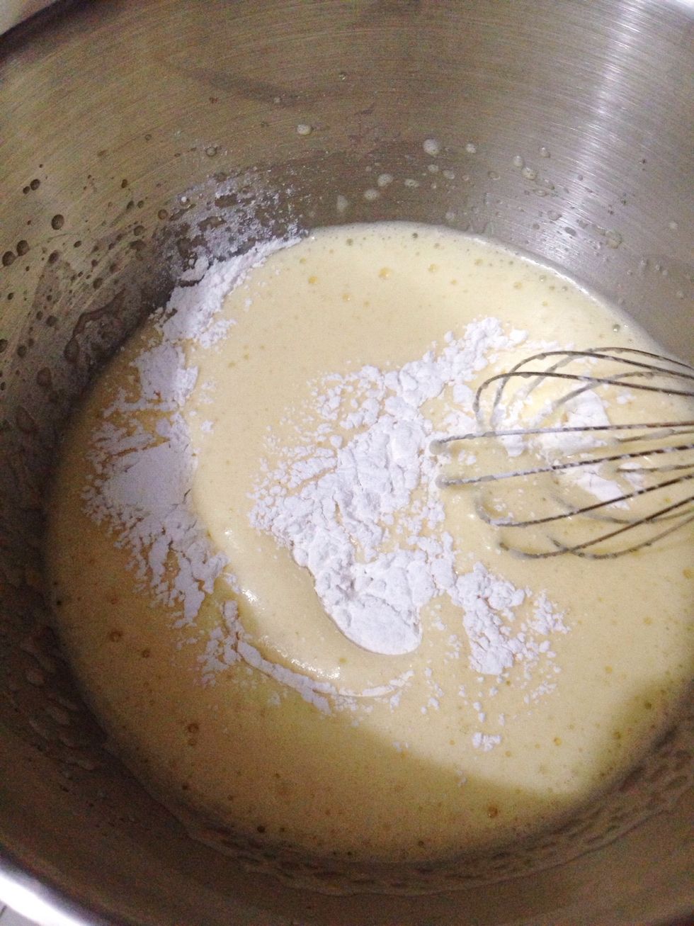 Then lower your mixer speed, add in sifted flour little by little and mix until all combined