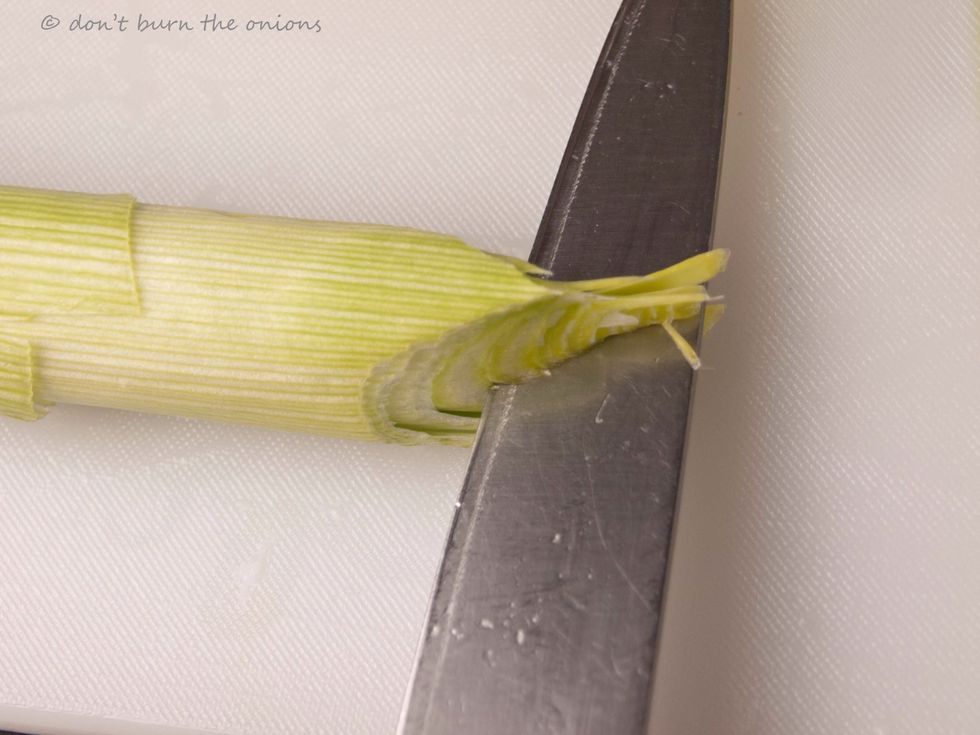 Then make a deep cross on the base with your knife. For more detailed instructions visit http//: wwww.dontburntheonions/category/cooking-without tears/tips-and-techniques/
