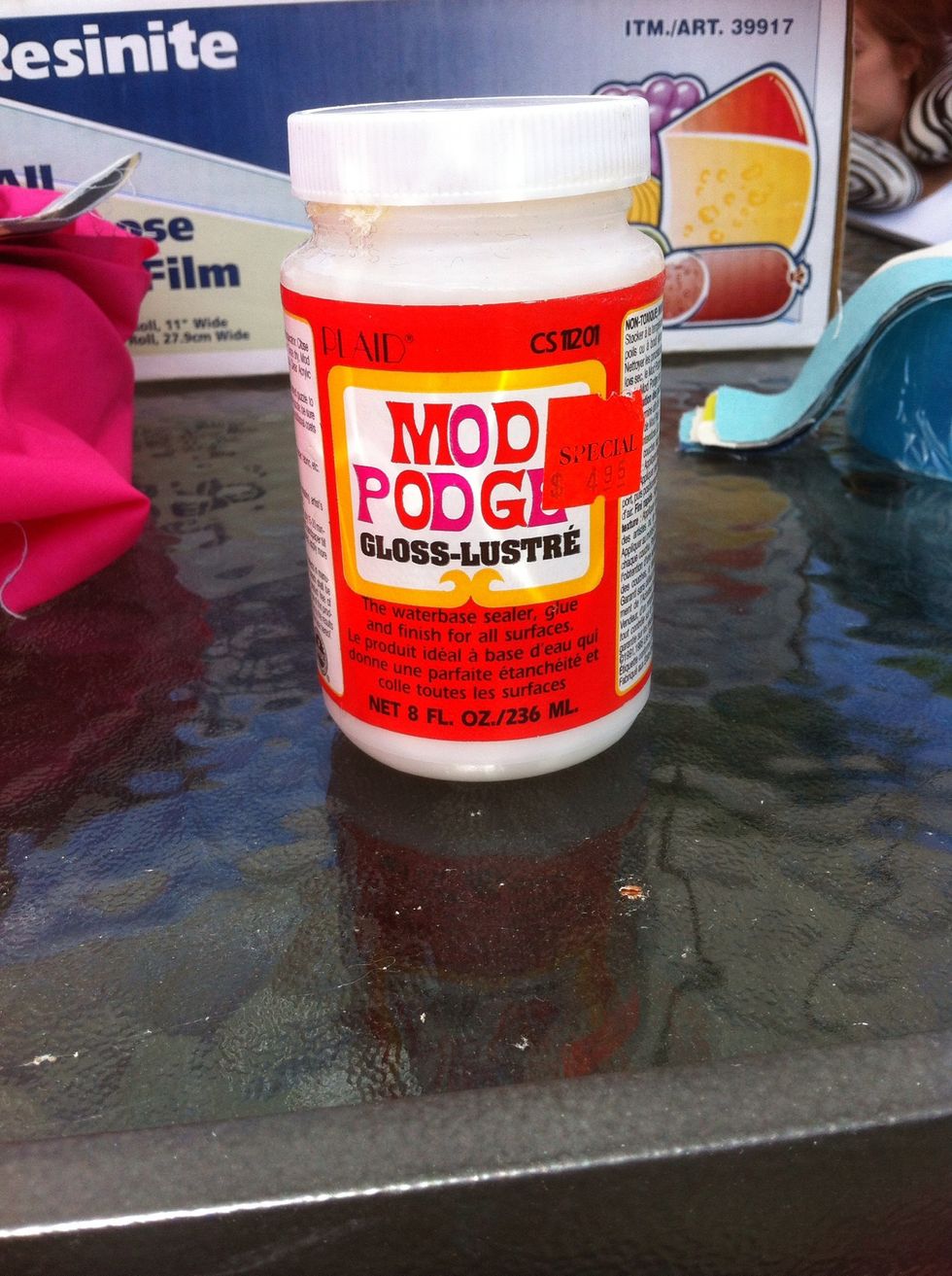 Then, mix equal parts of modpodge with water in another bowl