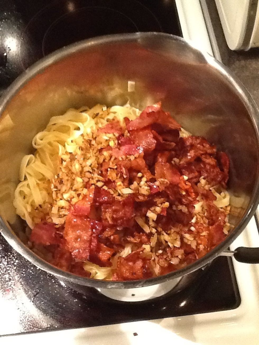 Then mix pasta, garlic and bacon.