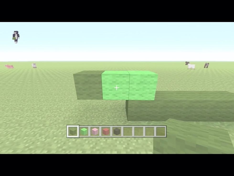 Then on either side put to light green wool and a green wool on the side like so