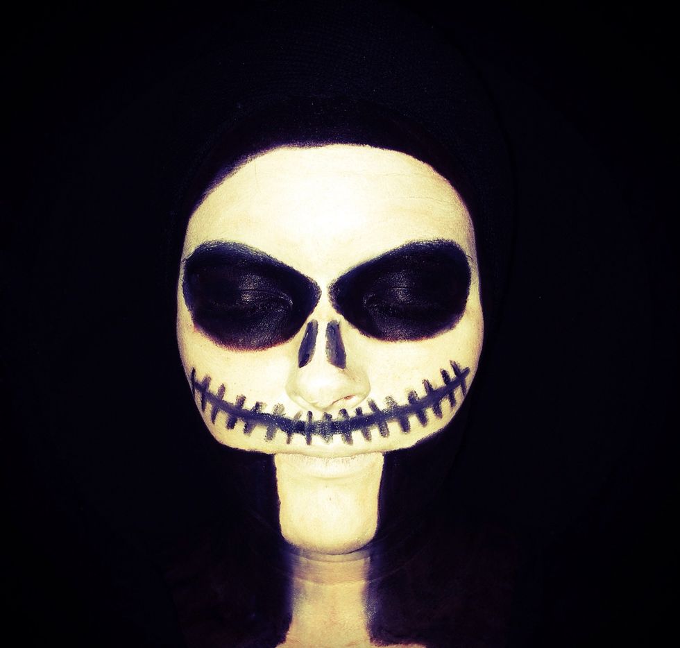 Then paint the rest of face, hair, neck and chest black.
