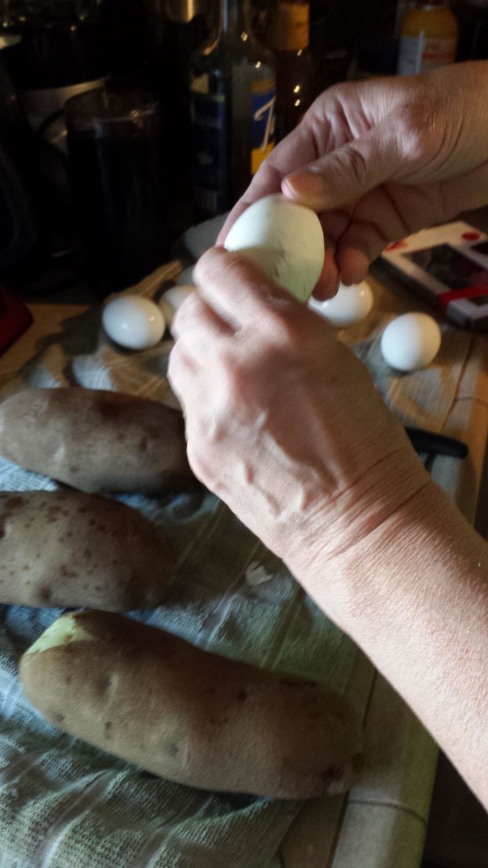Then, peel the 5 eggs and cut them into halves, halves again, and then into small pieces. Then add them to the bowl.