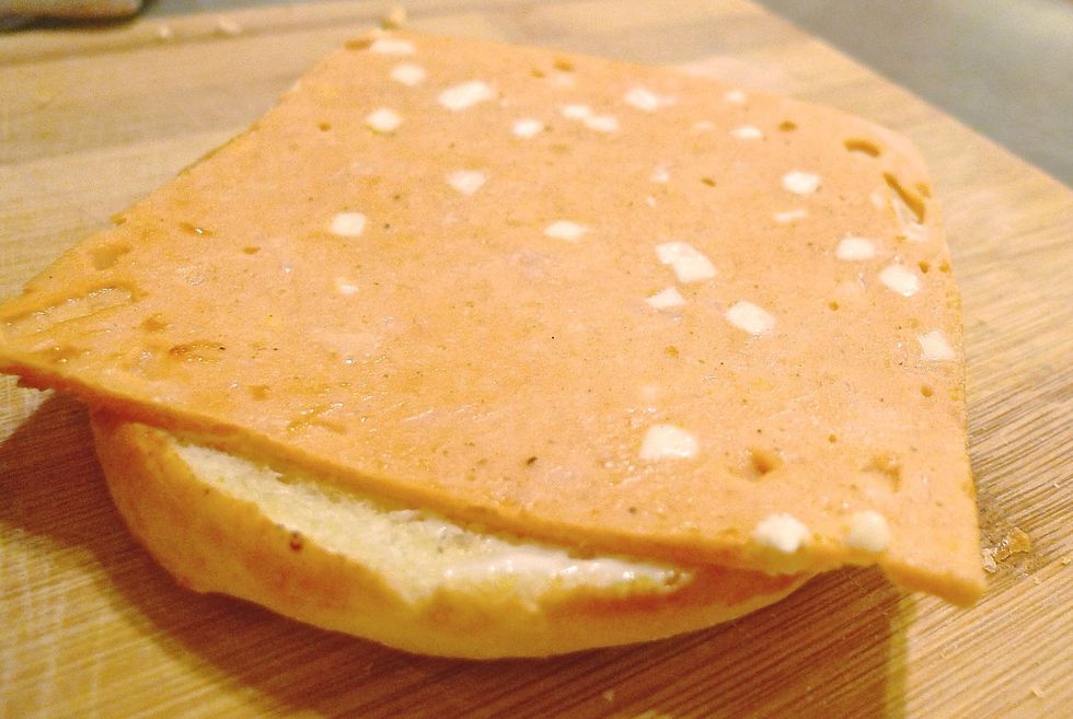 Then place a piece of cheddar cheese chicken slice over it.