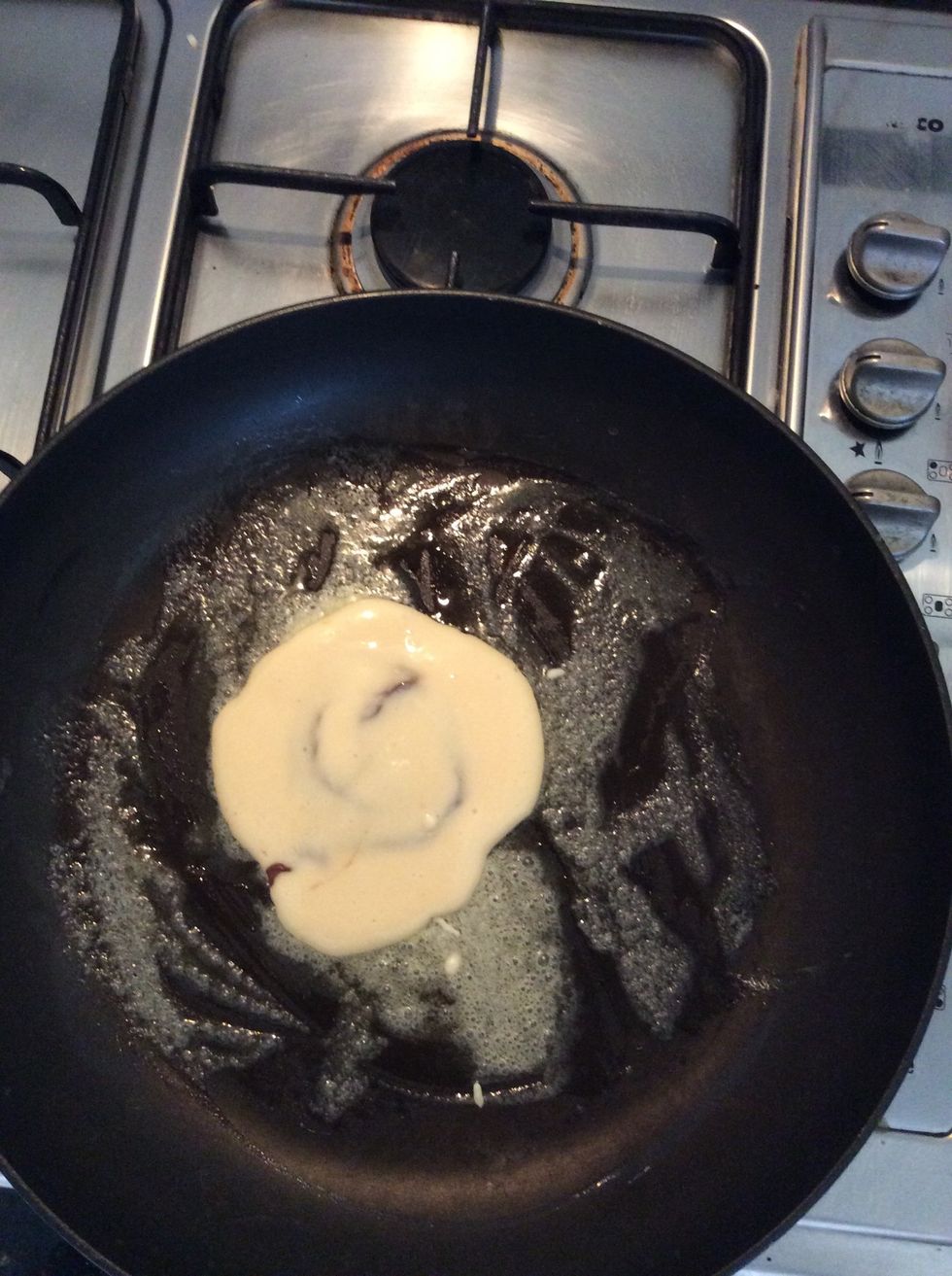 Then place another tablespoon of pancake mixture on top if the Nutella disk, make sure the disk is all fully covered.