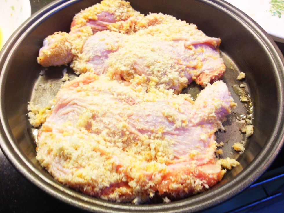 Then place the breaded chickens in the pan.