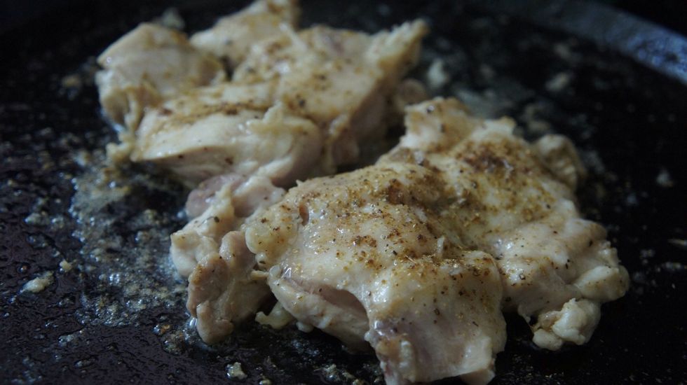 Then place the chicken thighs on the pan and shallow fry it...