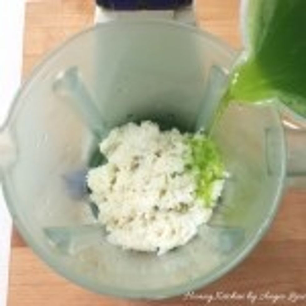Then place the fermented rice into the blender. Add in 1 cup (250 ml) of the green pandan water.