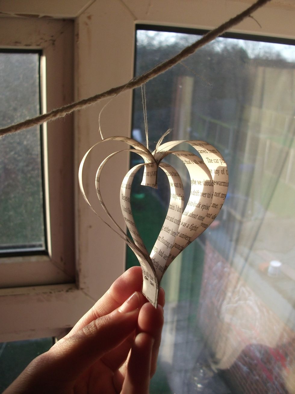 Then place the FIRST knot so that it's UNDER the string and then tie another knot OVER the string - slowly so that it all doesn't bunch up. And then one more simple knot to hold it in place.