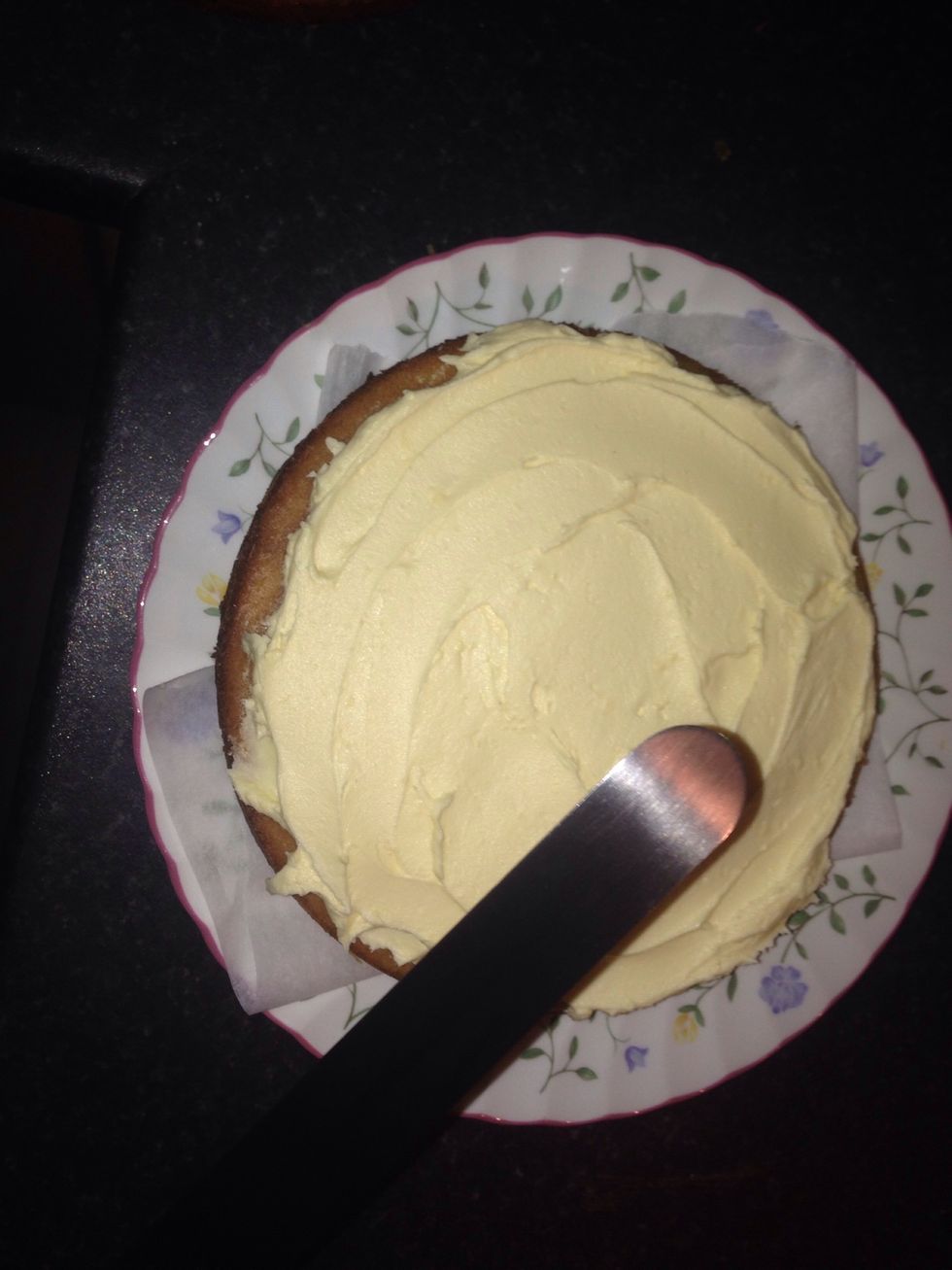 Then place the icing over the sponge that's on the plate making sure it's nice and even