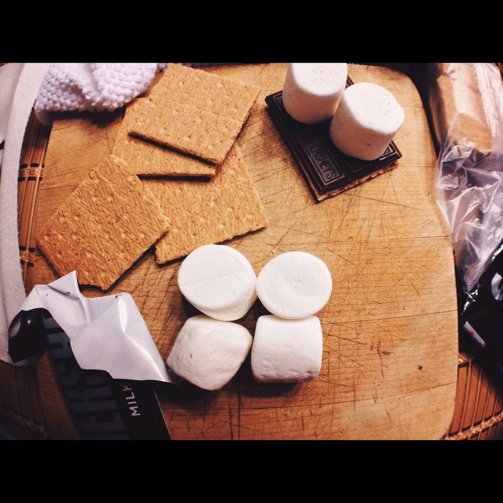 Then, place the marshmallows on top of the chocolate bar. Next, you wanna place this on a plate and microwave on high for 10-15 seconds or until the marshmallows beings to puff up.