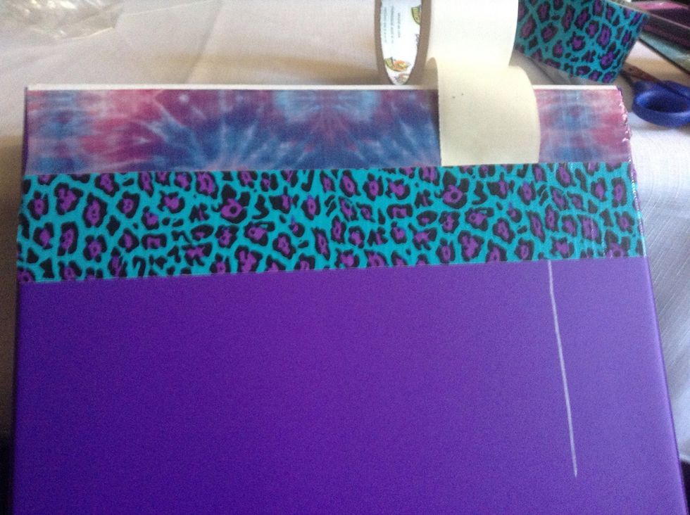 Then place the next strip, overlapping the white tape and the stripe, using the same distance as before.