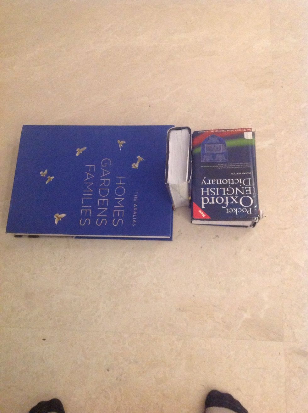 Then place the other long strong book as shown.