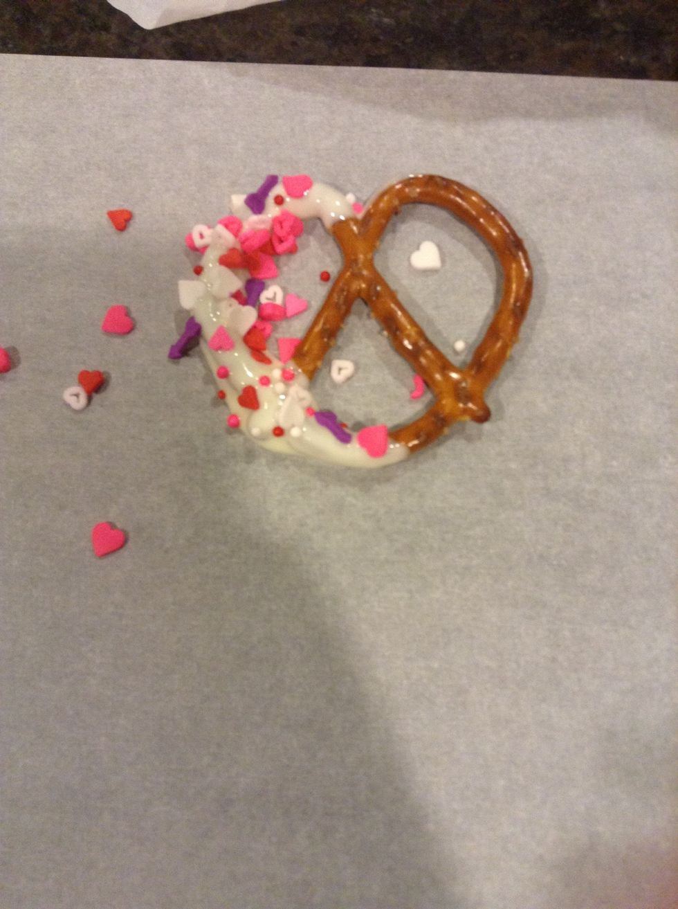 Then place the pretzels on the parchment paper, add sprinkles if you want to, it makes them look 10x better!!