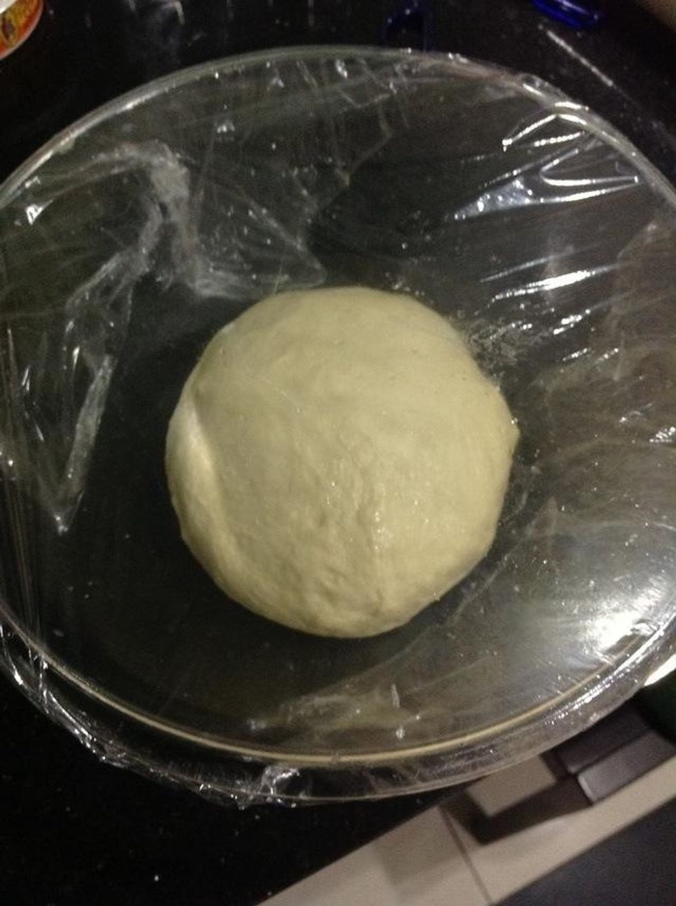 Then place your dough in it and cover it with plastic wrap.