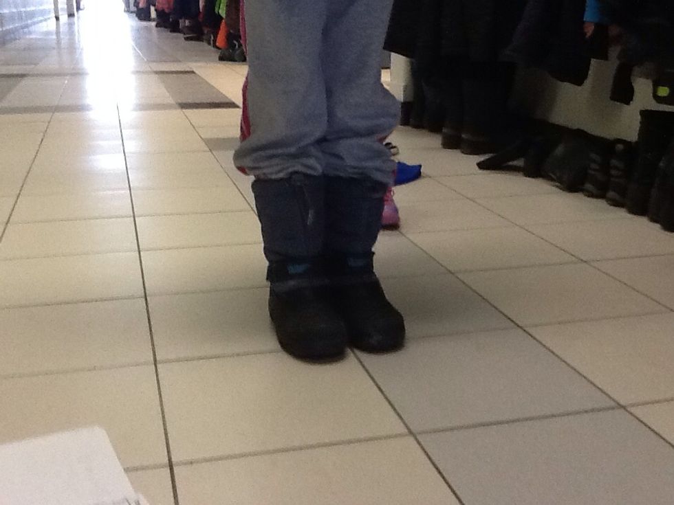 Then, place your feet in a pair of boots. Make sure to lay on a pair of socks so your feet don't get cold.