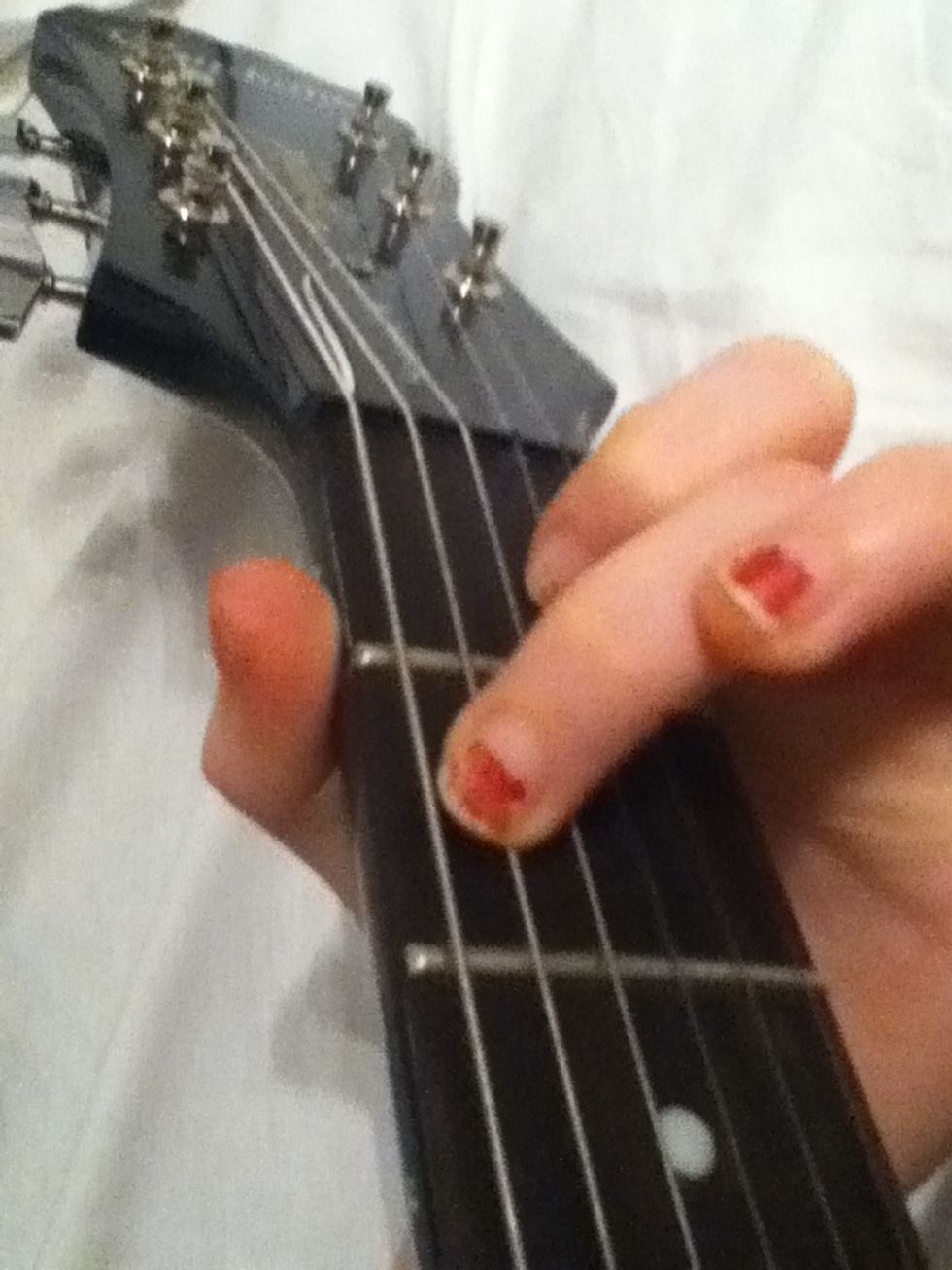 Then place your middle finger at the second string (A string) on the second fret.
