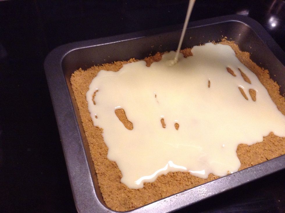 Then poor your sweetened condensed milk over top of your mixture. Make sure to poor it evenly