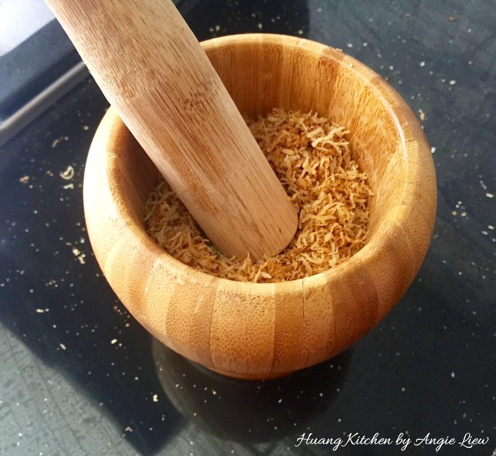 Then pound the kerisik (toasted coconut) in a mortar as this will help release some of the oils within as well as to intensify the nutty aroma. Then set aside the pounded kerisik to cool before use.