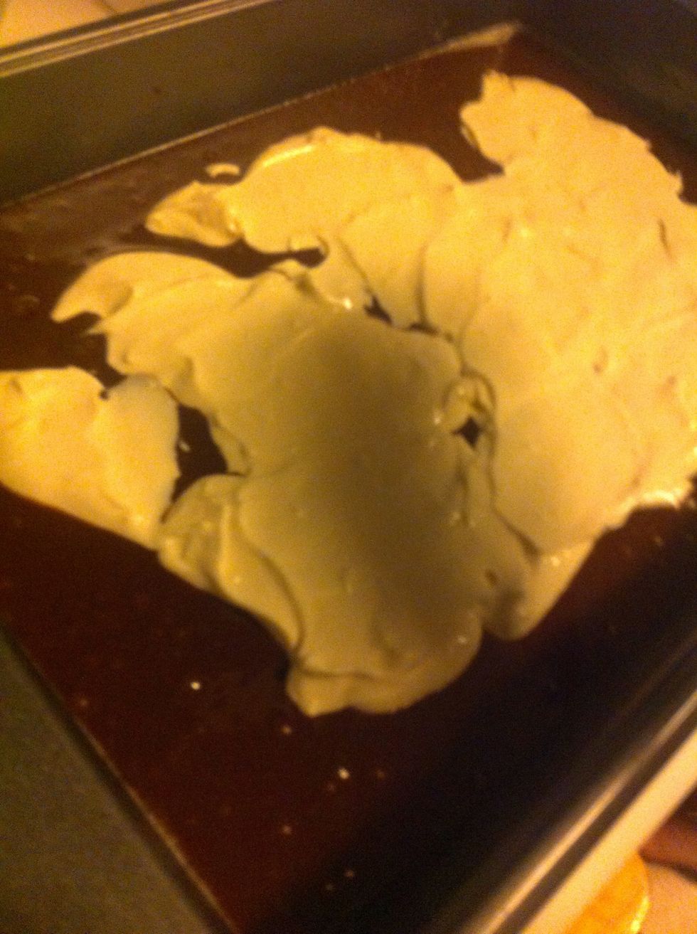Then, pour the cheesecake mix over the brownie mix and spread it