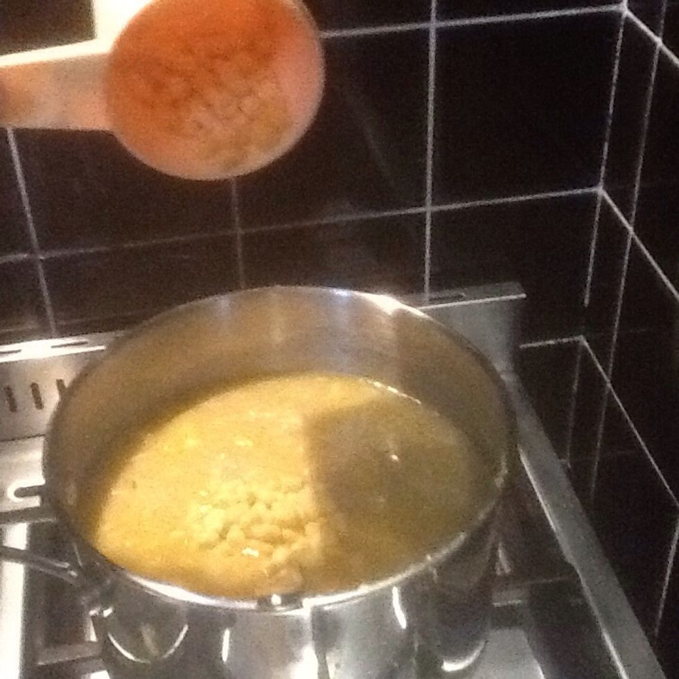 Then pour the contents of the pan into a large pot and pour the stock into the pot as well. Then add a cup of corn kernels.