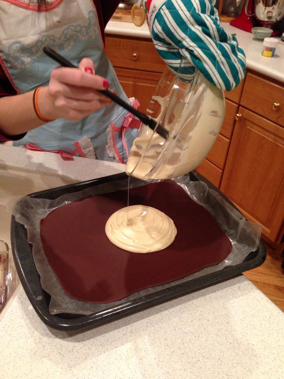 Then pour the white chocolate onto the dark