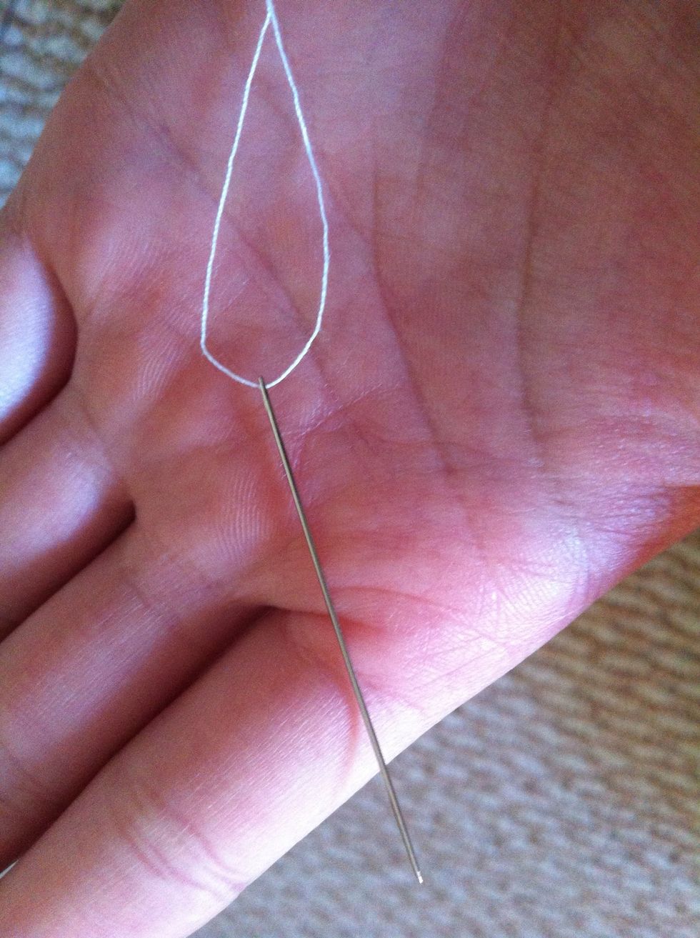 Then prepare a needle with white thread.