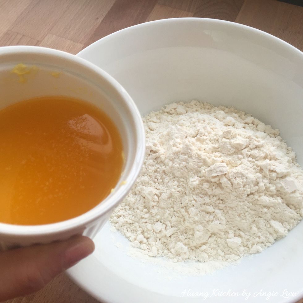 Then prepare the OIL dough. Combine sifted flour and melted margarine in a mixing bowl.