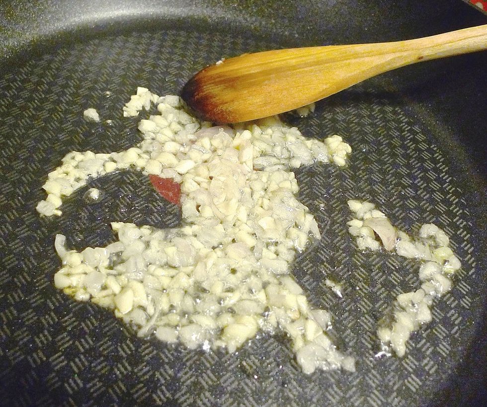Then prepare to cook the marmite sauce. Leave 1 tablespoon oil in the wok or pan. Add in chopped garlic and shallot. Fry till aromatic.