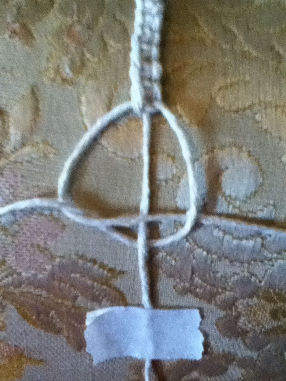 Then pull it under the left thread's loop and pull both ends gently to create the square knot. I will demonstrate how in the next step