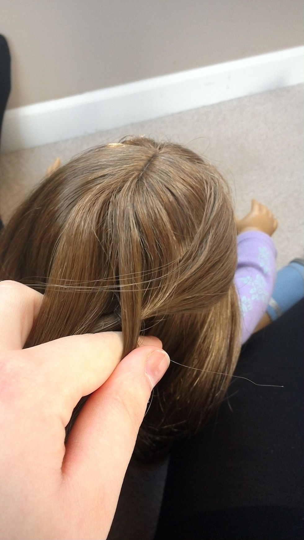 Then pull it under the middle strand of hair.