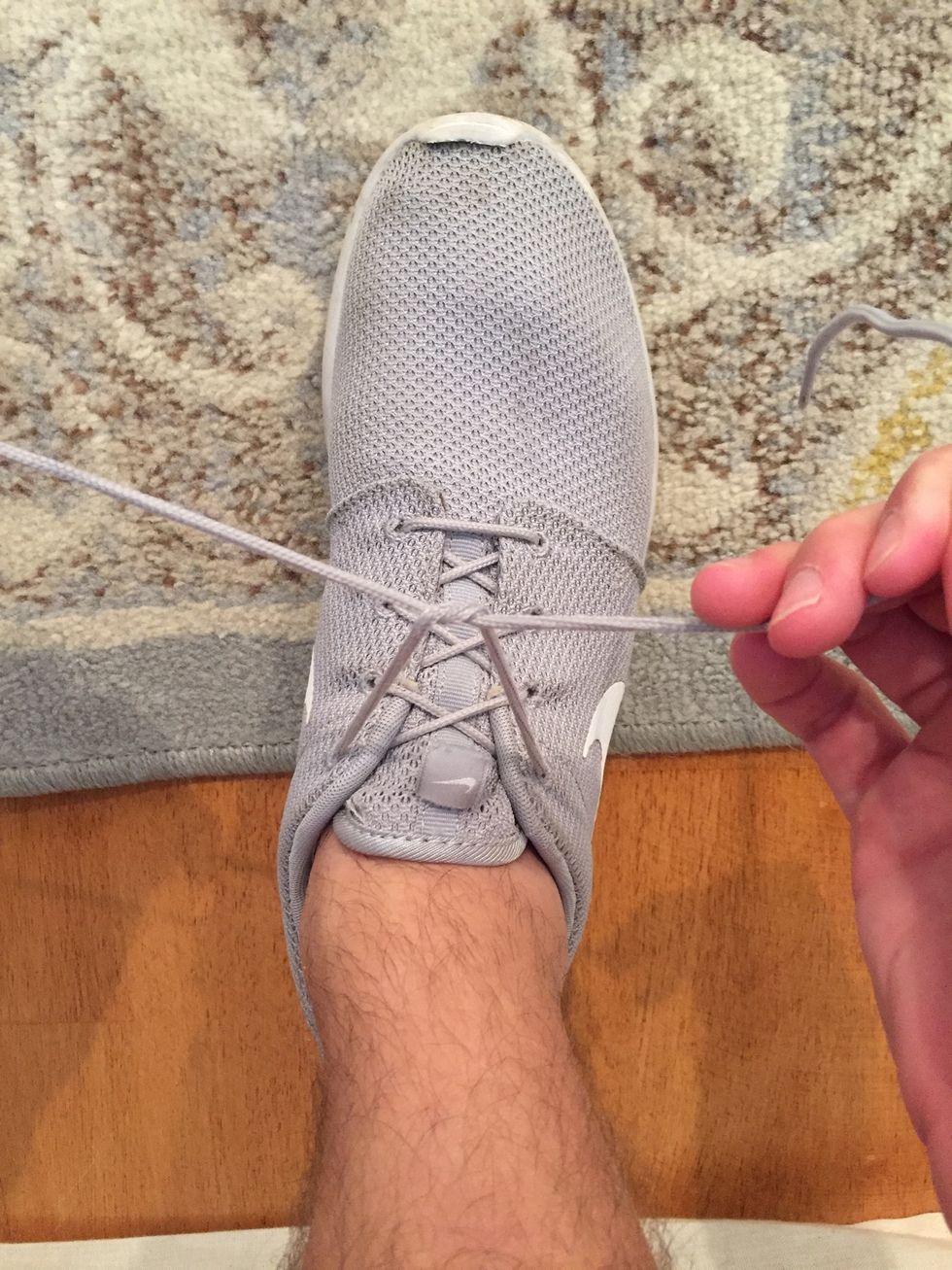 Then, pull the laces outward until the "crossed over" part of the laces touch the arch of your foot