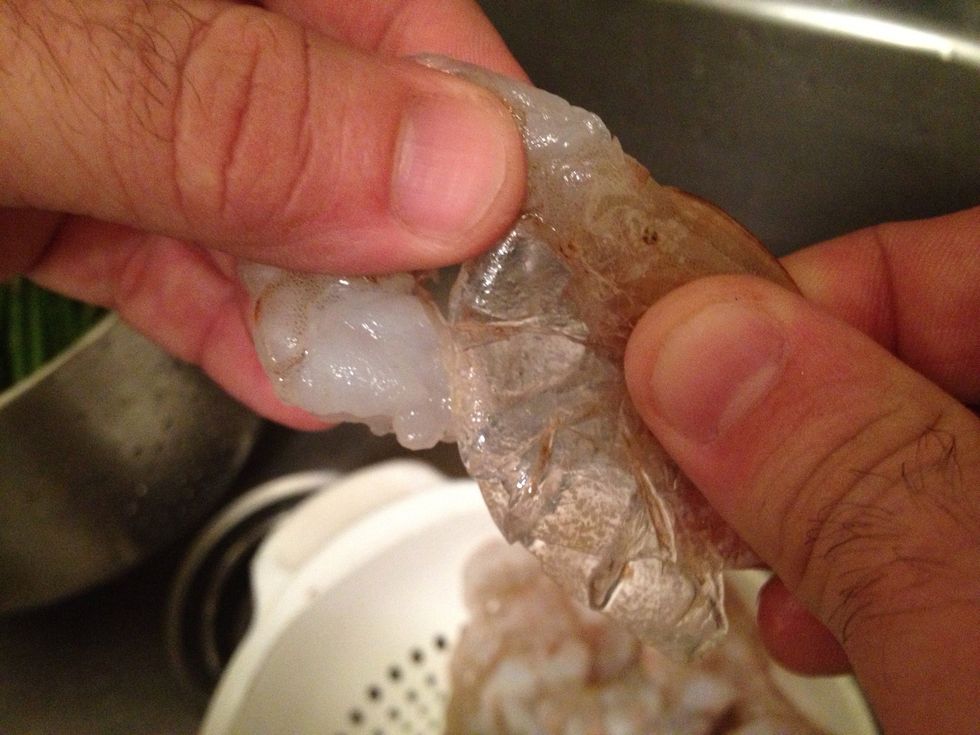Then pull the tail of the shrimp off by gently squeezing so as not to break the meat of the tail off .