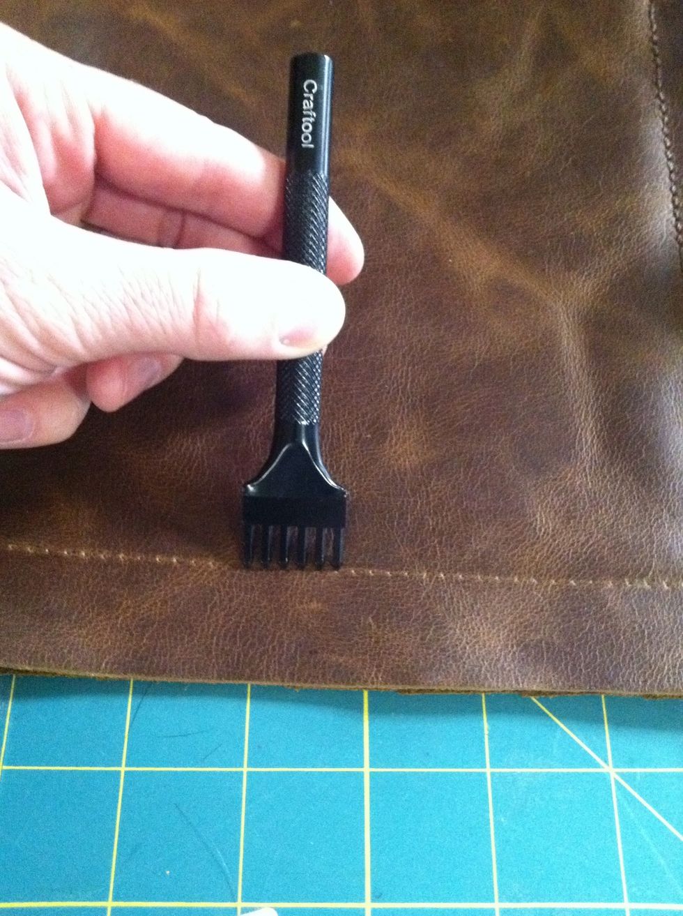 Then punch the holes with a leather hole punch. I punched through both leather pieces at once so they would line up perfectly.