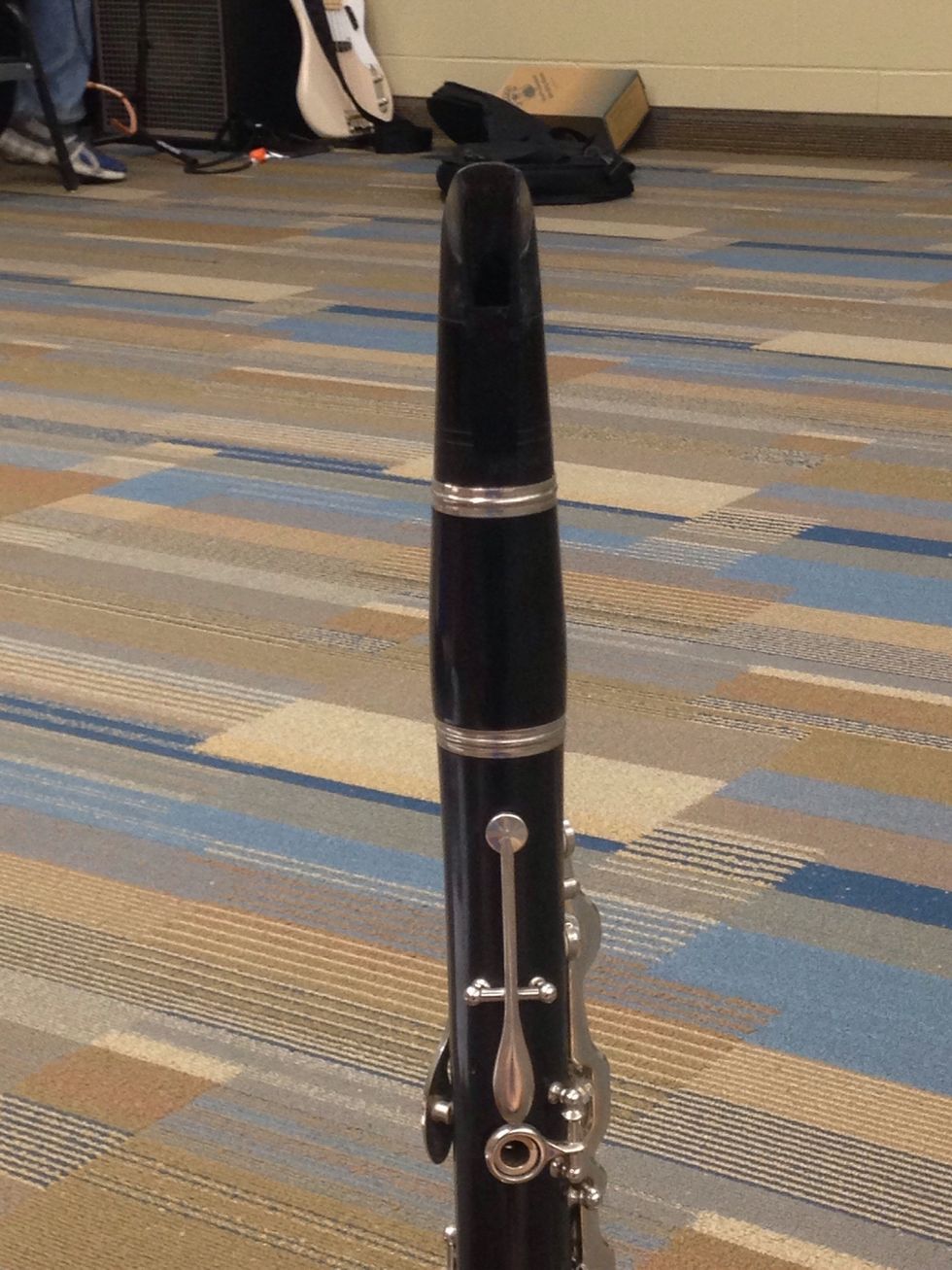 Then, push the mouth piece onto the barrel. Make sure the flat part of the mouth piece is facing the back.