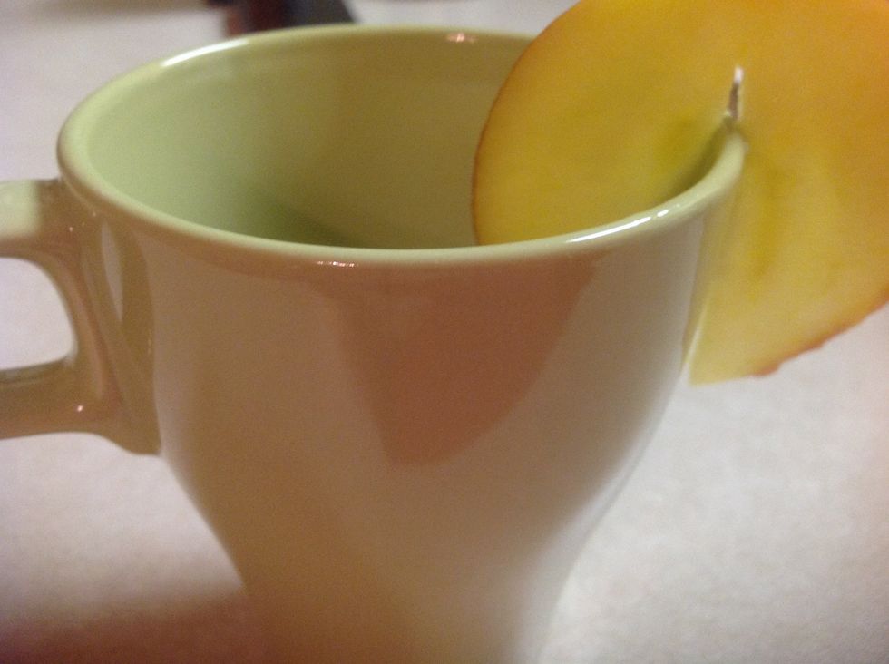 Then put a piece of the apple on the cup!