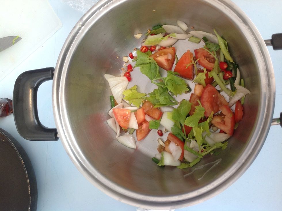 Then put all of the ingredients in a bowl and pour in the fish sauce and the sugar. Mix it together. Then take the lemons and squeeze them over the bowl.