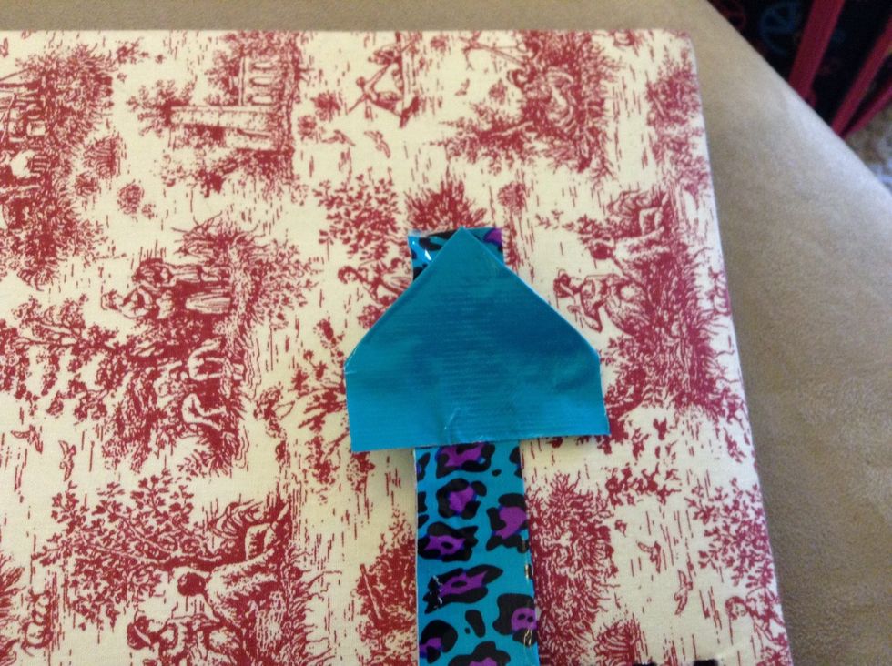 Then put it on the folded piece so that the point is in the middle