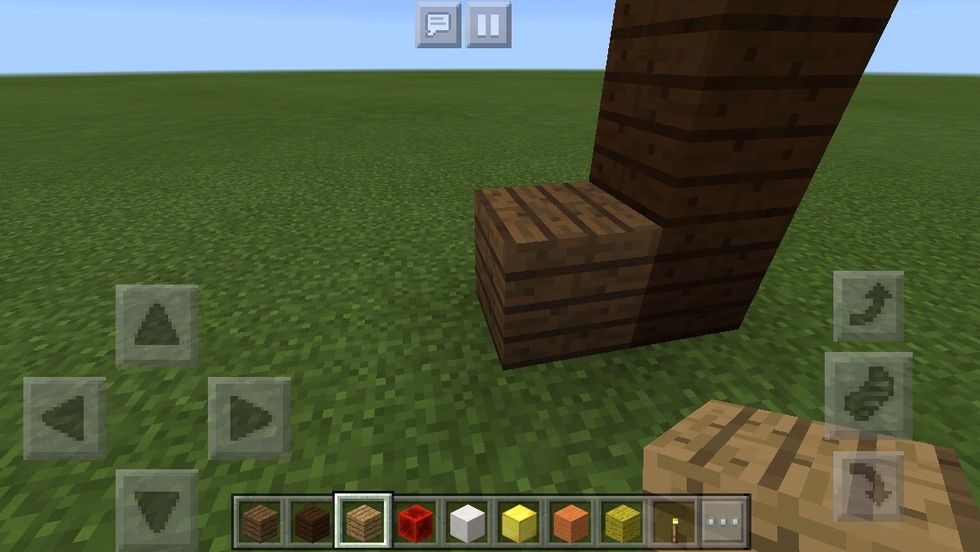 Then, put one block of Spruce wood plank on the left of the stack of Dark Oak wood planks.