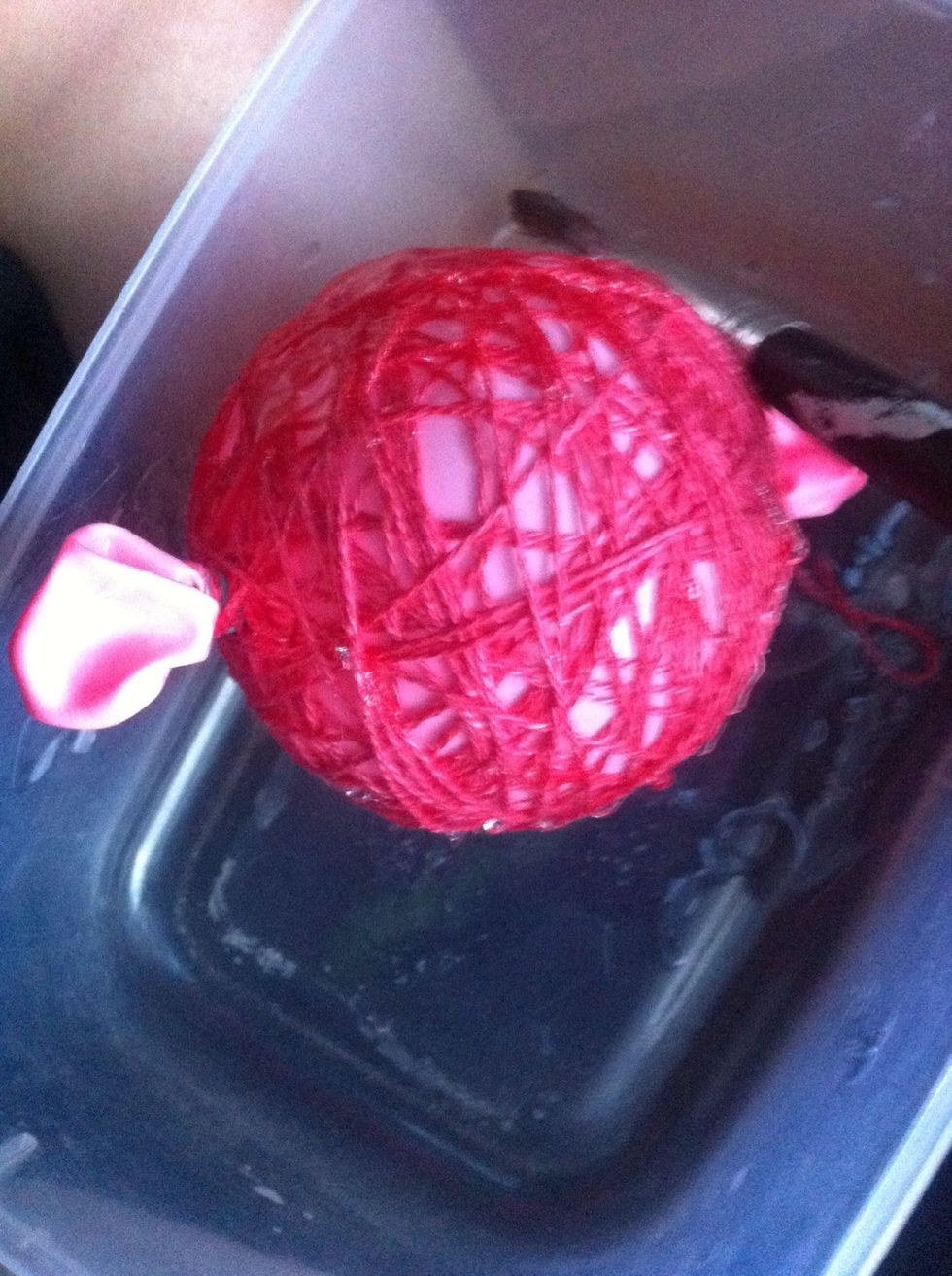Then put one in a container to avoid mess and pour craft glue on the ball and dab, until all is covered.