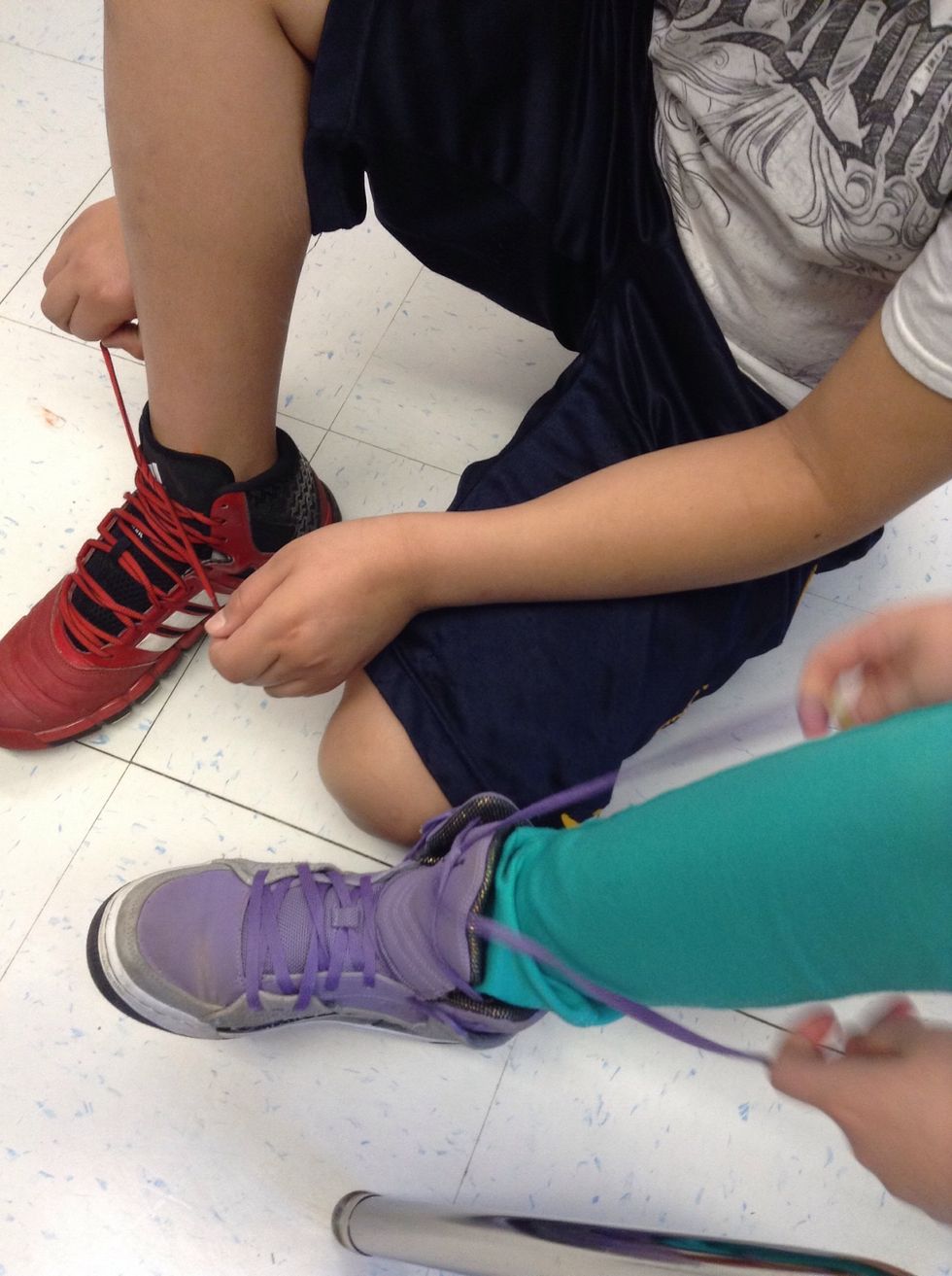 Then put one of the laces in the hole and pull on the laces.