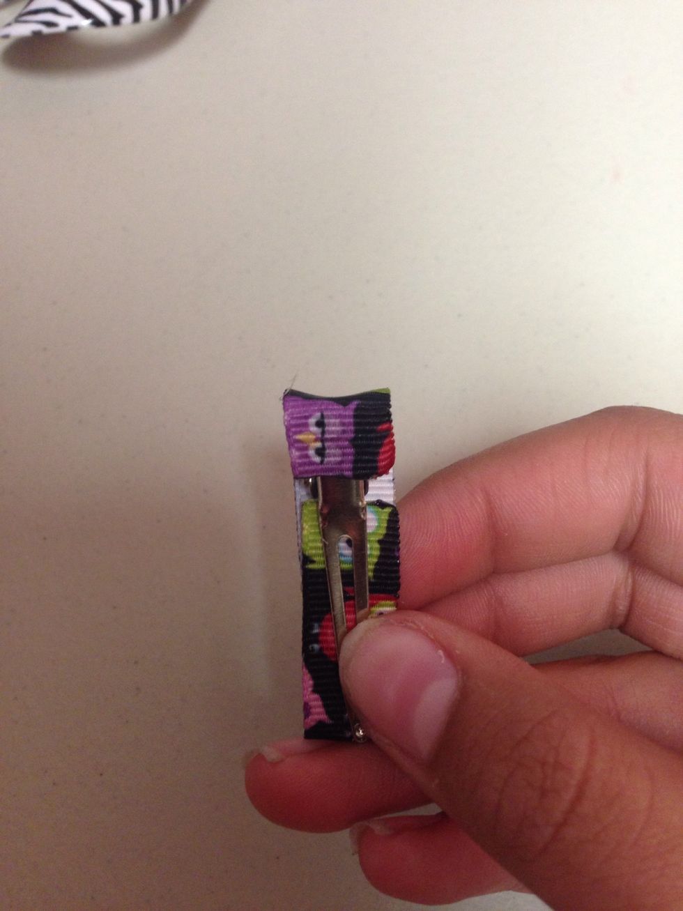 Then put some glue on the back and put the ribbon over it