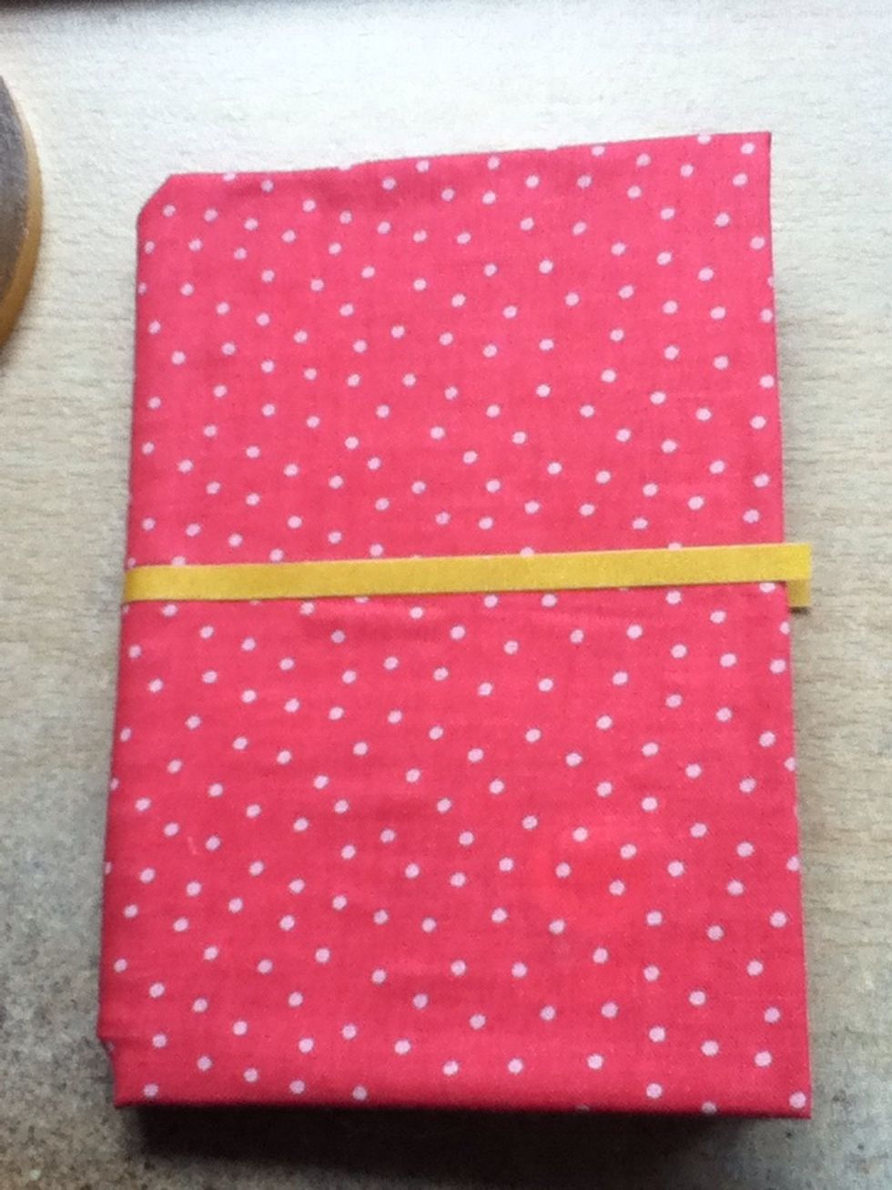Then put some tape around the middle of the notebook. (It needs to go all the way around the notebook)